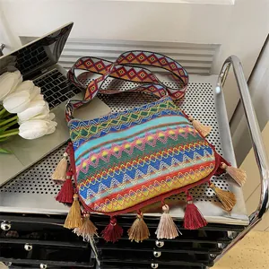 Ethnic bohemian crossbody bag with colorful woven patterns, tassels and wide strap