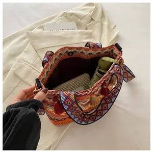 Detail view of ethnic bohemian woven tote bag showing spacious interior and tassel fringe