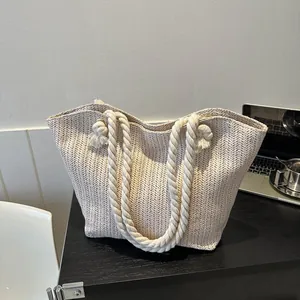 Chic beige straw tote bag with woven herringbone pattern and cotton rope handle