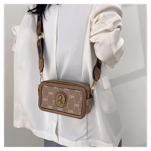 Dettagli della borsa a tracolla vintage con stampa monogramma e ampia tracolla decorata
