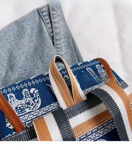 Detail of embroidered elephant canvas bag with durable striped woven handles