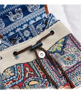 Detail of ethnic jacquard backpack featuring elephant pattern with drawstring and metal clasp