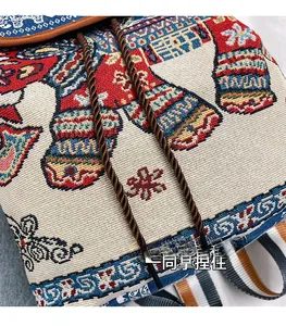 Detailed view of ethnic elephant embroidery and woven texture on this jacquard backpack