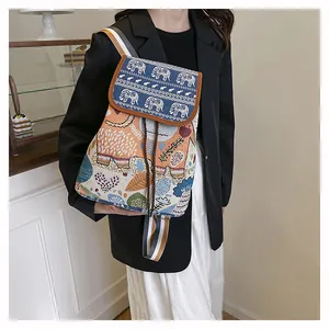 Detailed macro view of ethnic style elephant embroidery on drawstring flap backpack