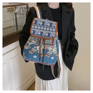 Detail of embroidered elephant backpack with drawstring closure and striped straps