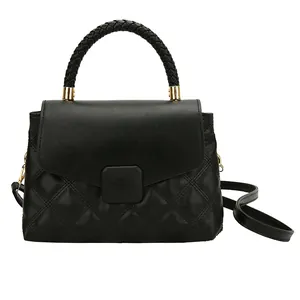 Classic black quilted crossbody bag with stylish woven handles and gold hardware
