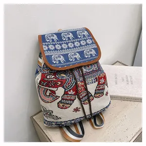Close-up of bohemian embroidered elephant backpack with woven striped strap and drawstrings