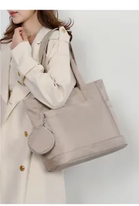 Dettaglio borsa tote in nylon kaki chiaro con tasca frontale e mini portamonete tondo