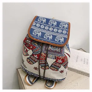 Detail of ethnic embroidered elephant pattern on woven canvas backpack with leather drawstring
