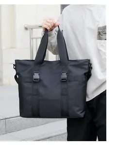 Détail d'un grand cabas en nylon noir avec boucles tactiques et anneaux métalliques