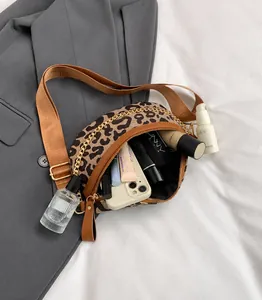 Leopard print waist bag showing spacious interior with phone, lipstick and perfume