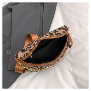Macro detail of the leopard print crossbody bag with black lining and interior pocket