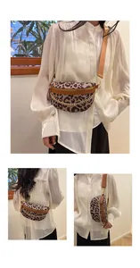 Detail view of leopard print crossbody bag with gold chain and fabric strap on model