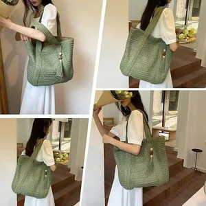 Detail of woven straw tote bag in grass green with bohemian tassel and wooden beads
