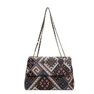 Ethnic bohemian woven crossbody bag with colorful geometric patterns and chain strap