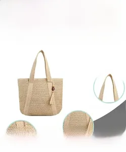 Macro view showing beige straw weave texture and tassel detail with wooden beads
