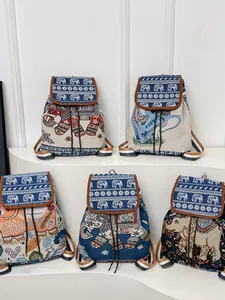 Ethnic embroidered elephant drawstring backpacks in various colors with woven texture