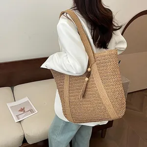 Large straw woven crescent tote bag with tassel and wood beads for beach or daily use