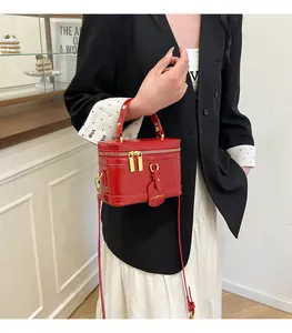Dettaglio borsa vanity in vernice rossa con doppia zip dorata e manico superiore