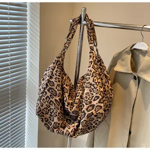 Macro detail of leopard print tote bag texture with silver adjustable strap buckle