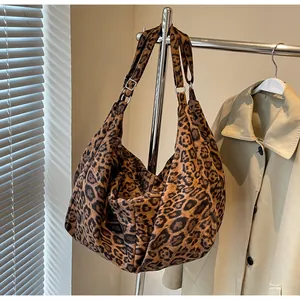 Detail of leopard print tote bag with metal buckle and adjustable shoulder strap