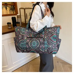 Detalle de un bolso de nailon con estampado paisley y varios bolsillos en un café moderno