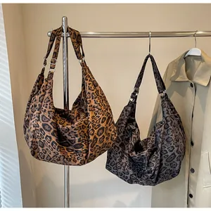 Detail of hobo tote bags with leopard prints and adjustable metallic silver hardware