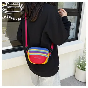 Close-up of a colorful nylon waist bag showing multi-color patchwork and adjustable strap