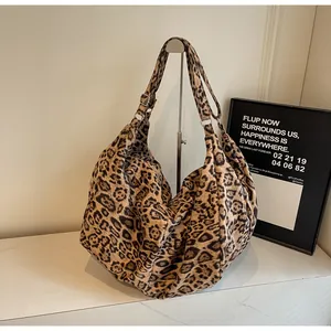 Detail of hobo tote bag with leopard print, wide adjustable strap and silver metal buckle