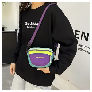 Detail view of colorful nylon fanny pack with adjustable strap and contrast zippers