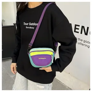 Close-up of waterproof nylon waist bag showing purple and yellow patchwork with zipper