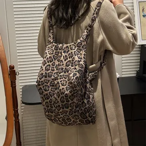 Large leopard print tote bag in soft fabric shown on shoulder over a light coat