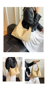 Vue détaillée du sac fourre-tout à carreaux kaki montrant la texture et le style porté épaule
