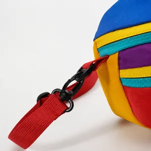 Detail of durable nylon fabric joints with red strap and plastic hooks on the waist bag