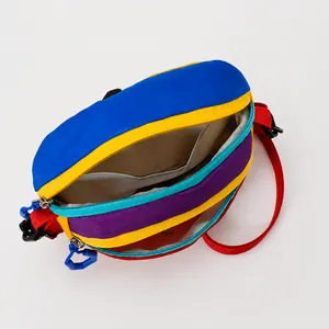 Internal view of colorful nylon waist bag with multiple pockets and adjustable red strap