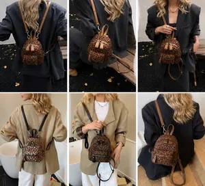 Detail view of mini leopard print backpack showing front zipper and adjustable straps