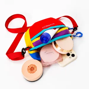 Macro detail of multicolored nylon fanny pack showing spacious interior for phone and cosmetics