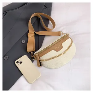 Détail de la sacoche banane crème à motif crocodile avec sangle marron et chaîne dorée