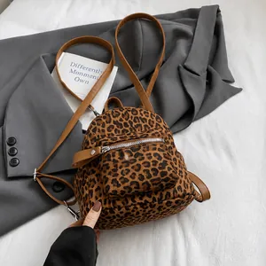 Detailed macro view of trendy leopard print mini backpack with brown leather straps