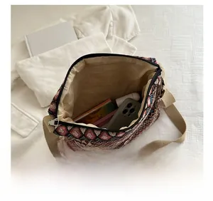 Interior view of ethnic geometric jacquard crossbody bag showing storage space for phone