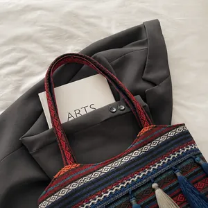 Close-up of comfortable woven shoulder strap on ethnic jacquard tote bag with tassels