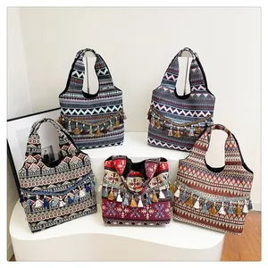 Vista dettagliata di cinque borse tote etniche con motivi boho e nappe decorative