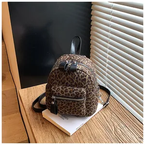 Mini leopard print backpack detail showing canvas texture and black zipper hardware
