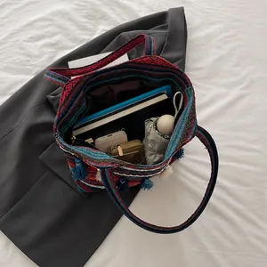 Spacious interior of ethnic jacquard tote bag with bohemian tassels and patterns