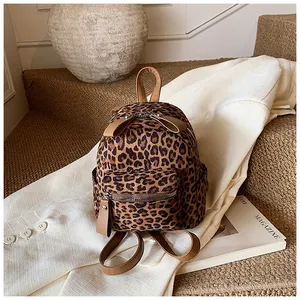 Mini leopard print backpack with suede texture and leather bow details on top