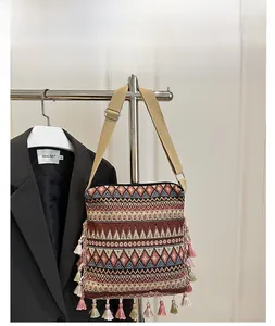 Close-up of bohemian jacquard crossbody bag with colorful geometric patterns and tassels