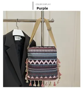 Detail of purple bohemian crossbody bag with geometric jacquard patterns and colorful tassels