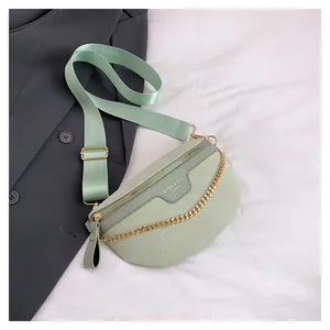 Détail du sac ceinture vert menthe à motif crocodile avec sangle large et chaîne