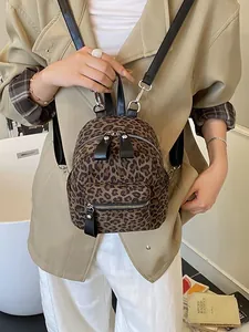 Chic leopard print mini backpack for women featuring leather straps and front pocket