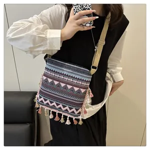 Detailed shot of ethnic geometric jacquard pattern and tassel accents on a bohemian bag
